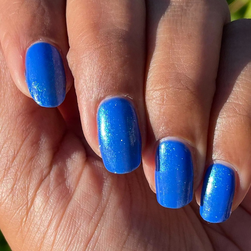 Blue For You Set featuring vibrant cobalt blue manicure with iridescent chrome shimmer on natural hand in sunlight