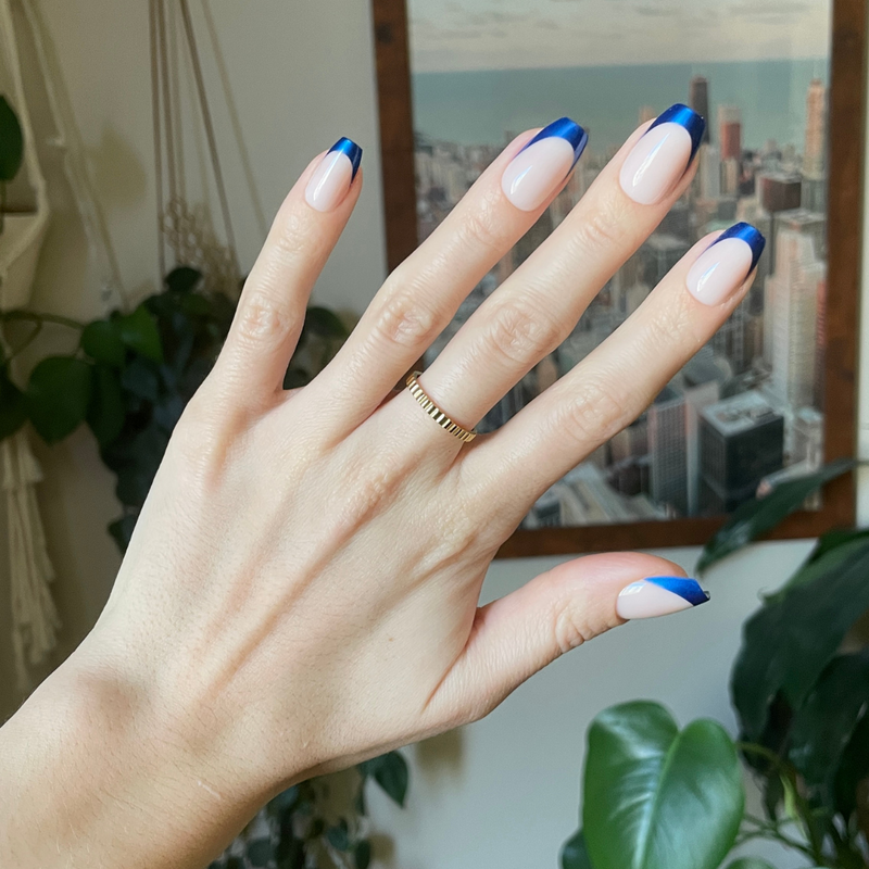 Blue Metallic French - Press-On | Medium | Coffin showing hand with medium coffin false nails featuring metallic blue french tips indoors