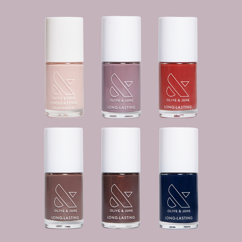 Six bottles of Olive and June Fall Long-Lasting Polish Set in muted and rich fall-inspired colors for manicures and pedicures
