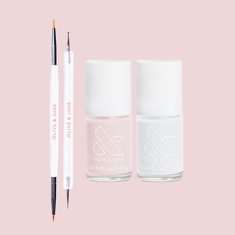 Polka Dot Mani Polish Set featuring two long-lasting nail polishes and dual-ended nail art tools on pink background