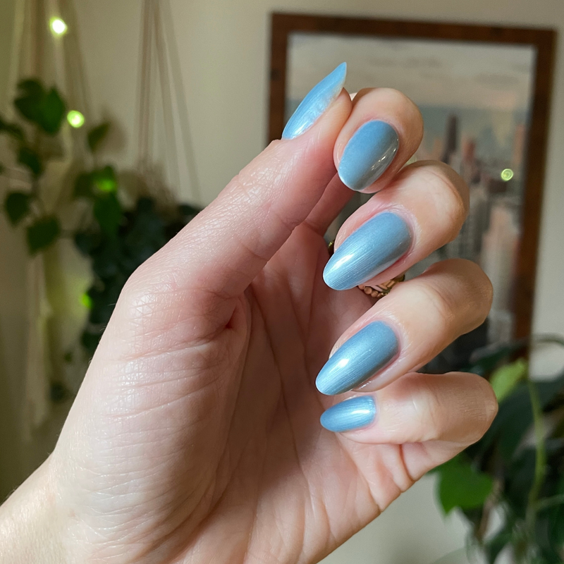 Same Day Next Year sheer shimmery blue gel polish on almond-shaped nails with a smooth glossy finish for an easy mani