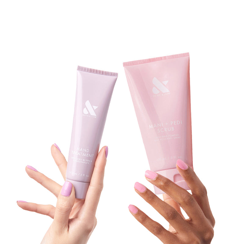 Refresh and Repair Duo with mani + pedi scrub and hand treatment held by hands with pastel pink and lilac manicures