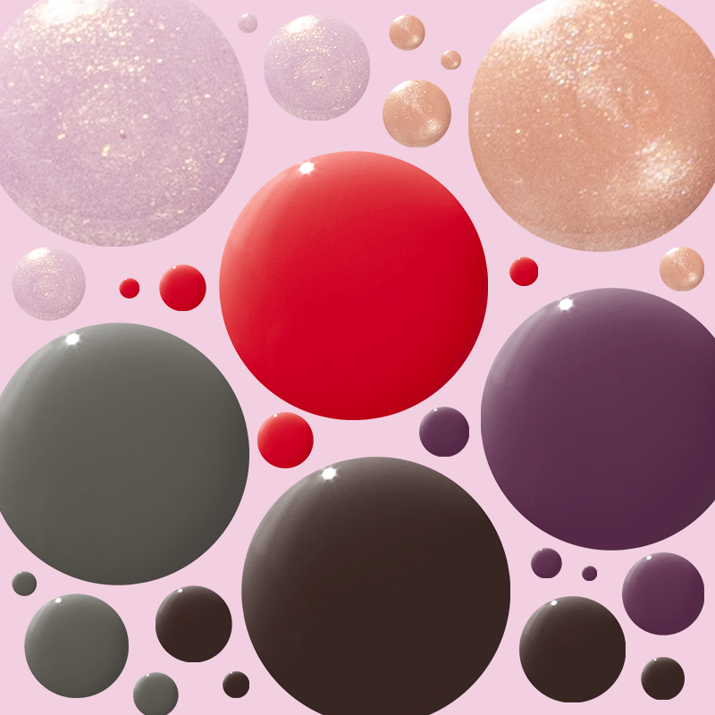 Glossy nail polish droplets in various shades representing the Sweet Treat Polish Set for vibrant at home manicures