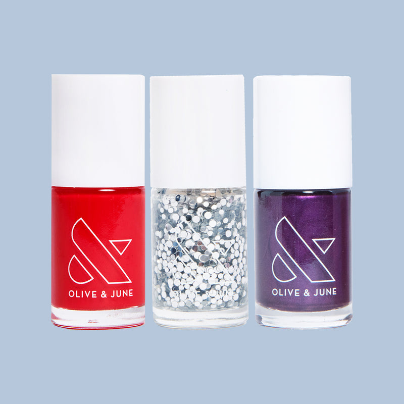 Three nail polish bottles in red, silver glitter, and deep purple from the Spicy Favorite Trio set by Olive and June