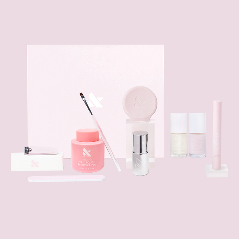 Pearl Mani System showing nail clipper, cleanup brush, polish remover pot, cuticle serum, and gel polish for at home mani
