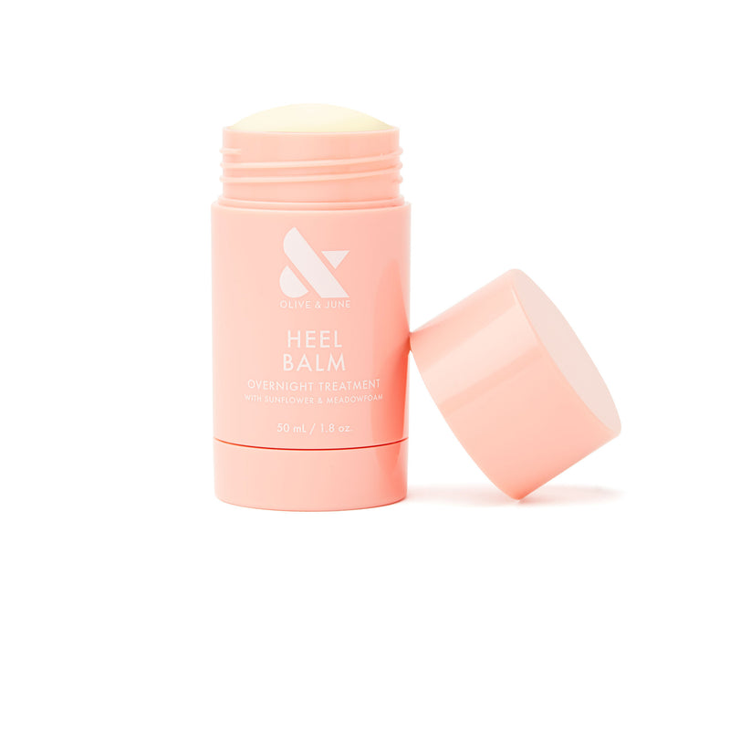 Open tube of Heel Balm overnight treatment for dry, cracked skin in soft pink packaging on white background