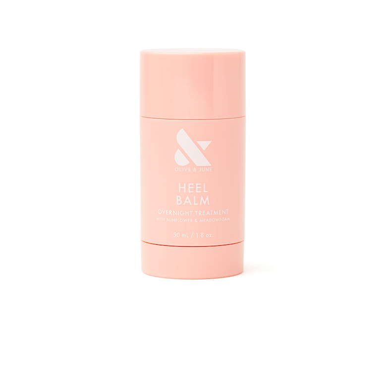 Pink stick container of Olive and June Heel Balm overnight treatment for dry, cracked skin care on white background