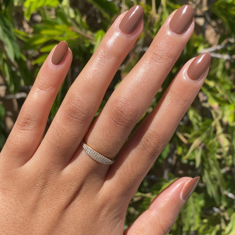 Tip Your Barista polished almond-shaped nails in rich espresso brown with a diamond ring shown in natural light outdoors