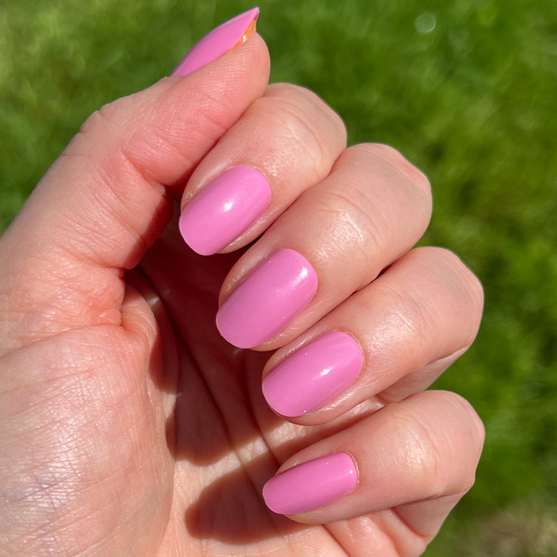 Hand displaying Grateful & Kind | Round | Short pure pink press-on nails in short round shape for easy at-home mani