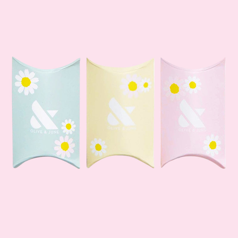 Spring Minis Set pillow boxes in pastel blue, yellow, and pink with white daisy designs on light pink background