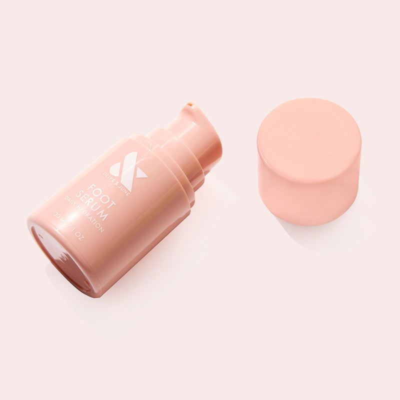 Open Foot Serum bottle in soft pink packaging shown with cap removed on pale background