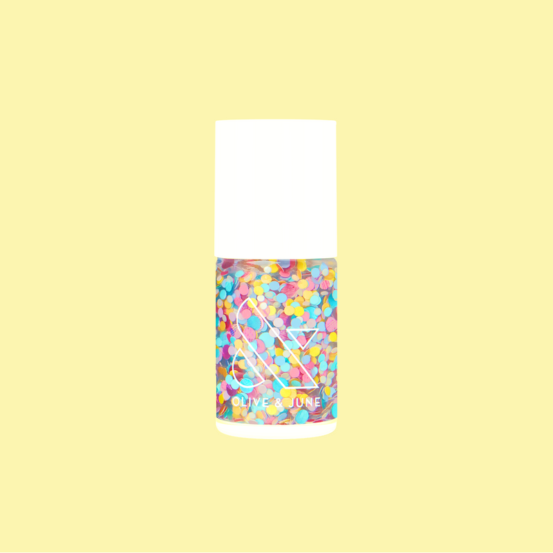 Bottle of Olive and June Sprinkle Cookie polish with rainbow confetti in a clear base on pale yellow background