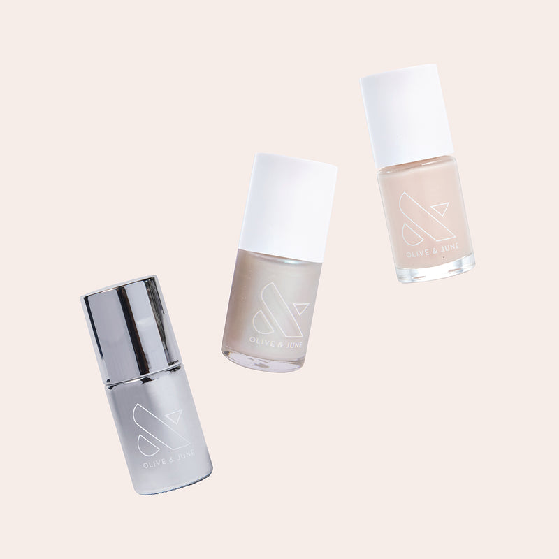 Three nail polish bottles in soft pearlescent shades from Olive and June’s Freshwater Pearl Set for layered manicures