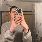 Person wearing red nails using Ally Rooker Super Stick Set taking a mirror selfie in a bathroom with tiled walls
