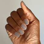 Hand with smooth nails painted in AW - Gel warm grey polish for a chic and durable manicure on natural skin tone