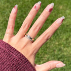 Layered Circles - Press-On | Medium | Oval nails with neutral base and burnt red circle accents on hand outdoors