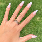 CCT - Press-On | Long | Almond showing hand with sheer pink long almond press-on manicure outdoors on grassy background