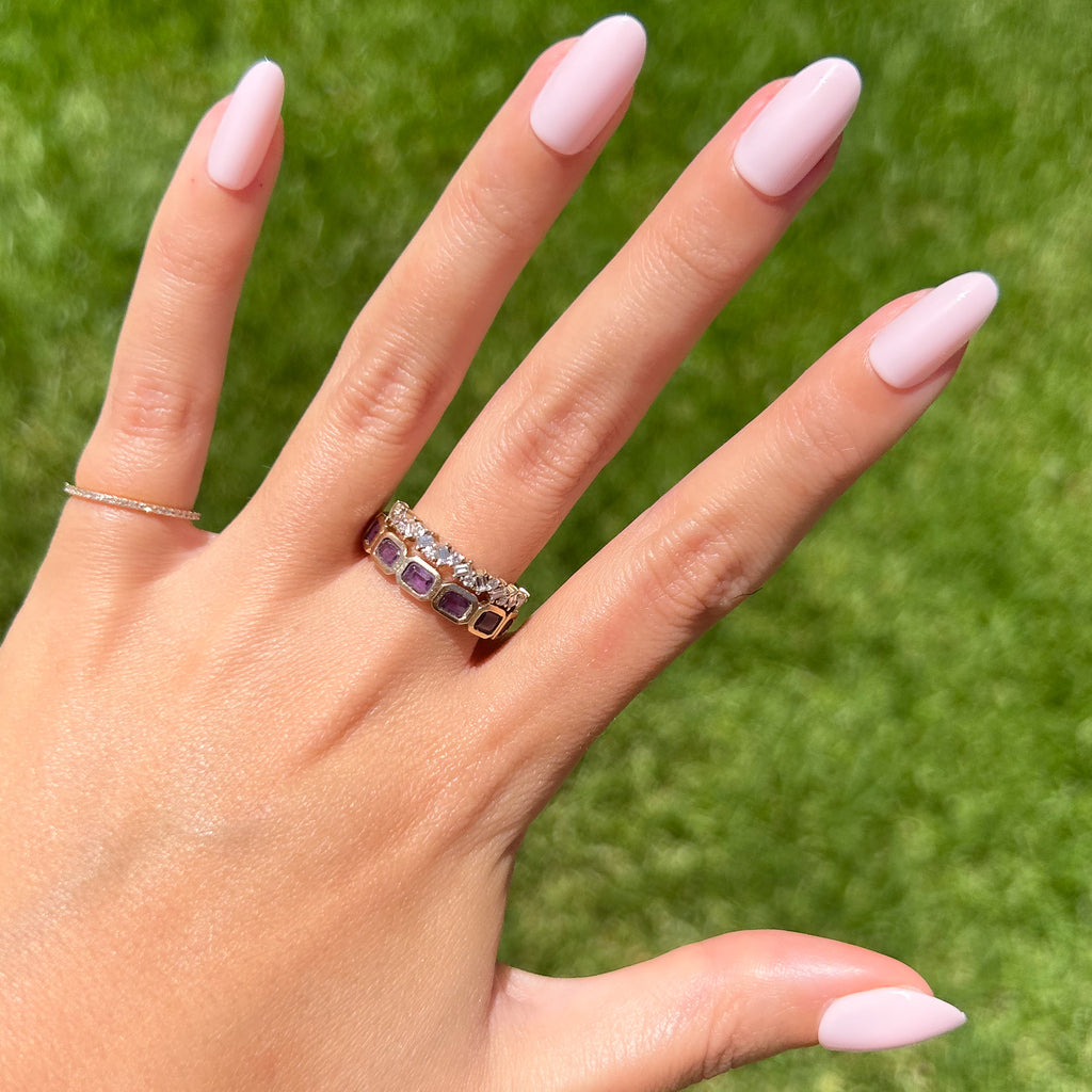 GH - Press-On | Medium | Oval showing hand with medium oval opaque glowy baby pink press-on manicure outdoors on green grass background