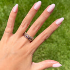 GH - Press-On | Medium | Oval showing hand with medium oval opaque glowy baby pink press-on manicure outdoors on green grass background