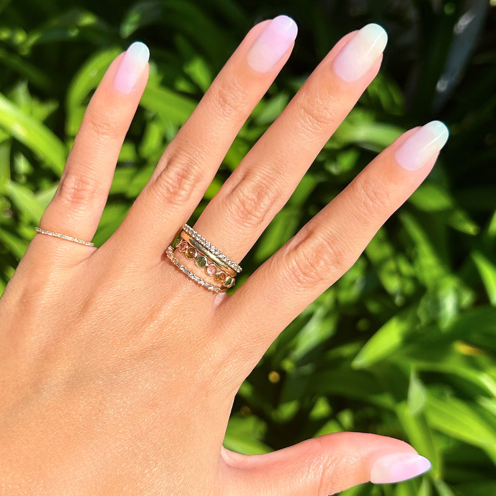 Tie Dye - Press-On | Short | Round showing hand with short round false nails in soft pastel gradient manicure outdoors