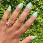 Hand with nails painted in a cool pastel green using Aced It - Gel for a smooth, long-lasting manicure at home