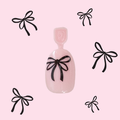 Biggest Bow On Top - Pressies | Short Medium | Round pink press-on nails with black bow design by Olive and June Biggest Bow On Top - Pressies | Short Medium | Round  Pressies