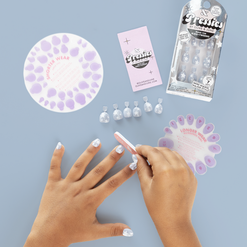Blue Jean Superstar - Pressies | Extra Short Short | Round showing kid filing nails with shimmery blue press on nails and white stars