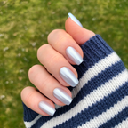 Blue Chrome - Press-On | Medium | Coffin showing hand with medium coffin pastel blue chrome press-on manicure outdoors