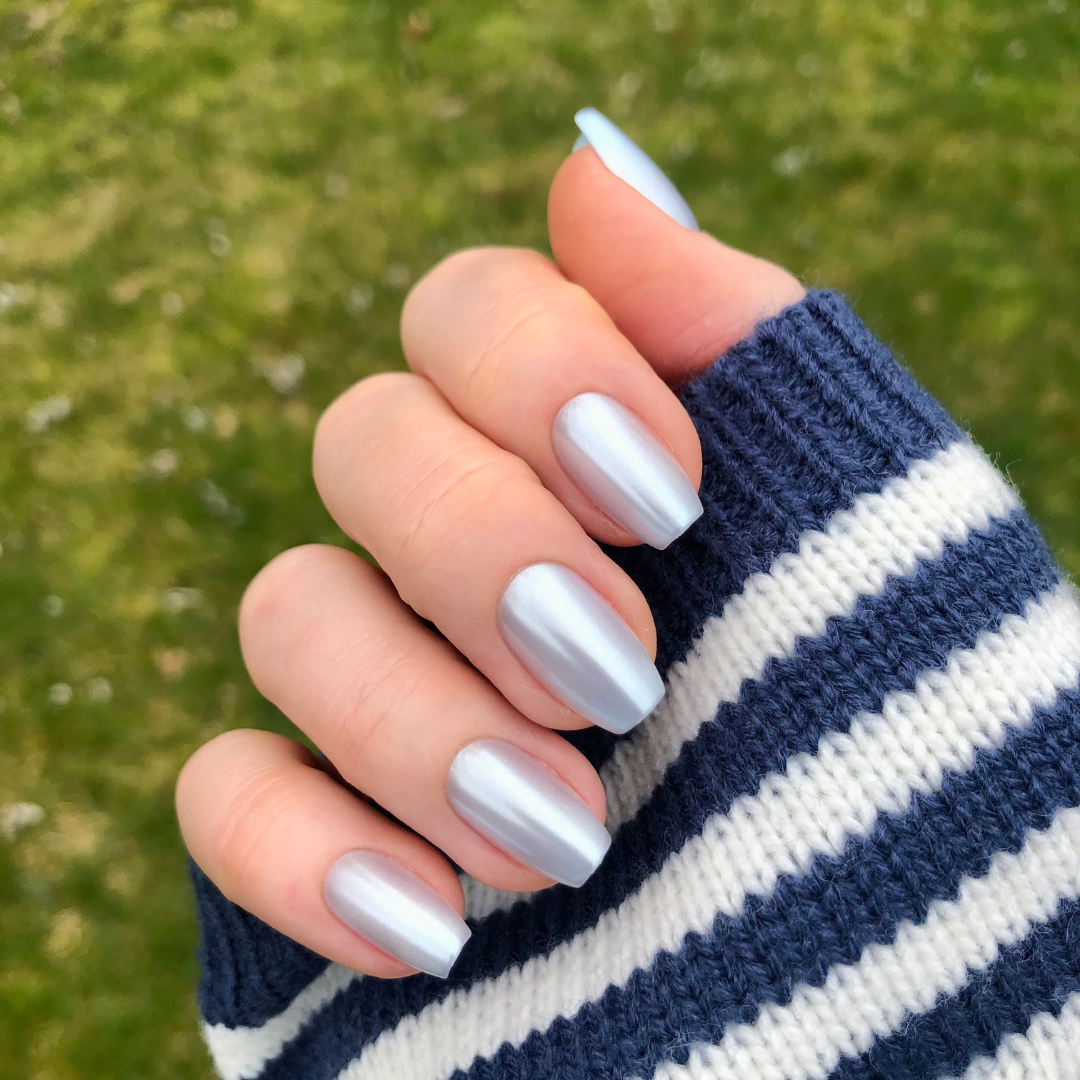 Blue Chrome - Press-On | Medium | Coffin showing hand with medium coffin pastel blue chrome press-on manicure outdoors