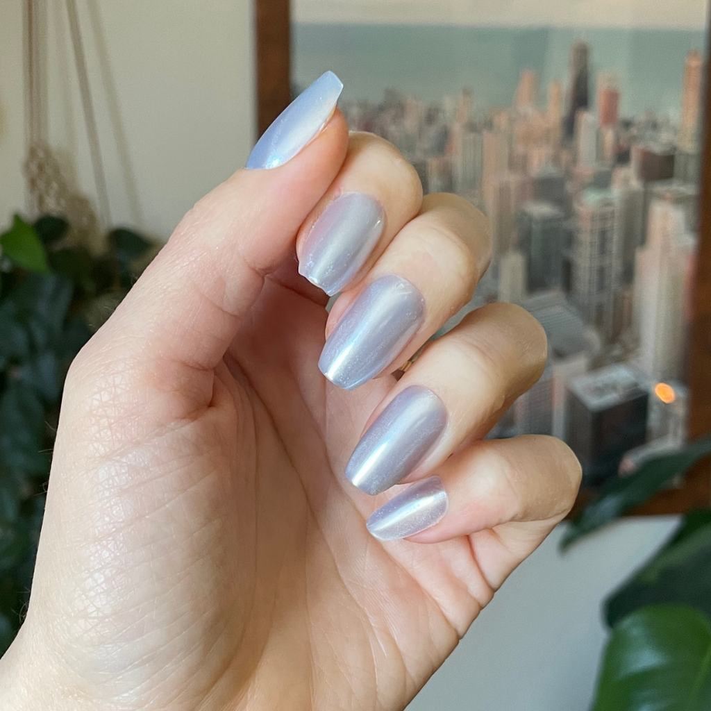 Blue Chrome - Press-On | Medium | Coffin showing a hand wearing pastel blue chrome medium coffin press-on nails indoors