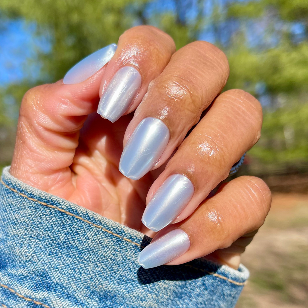 Blue Chrome - Press-On | Medium | Coffin showing hand wearing pastel blue chrome medium coffin press-on nails outdoors
