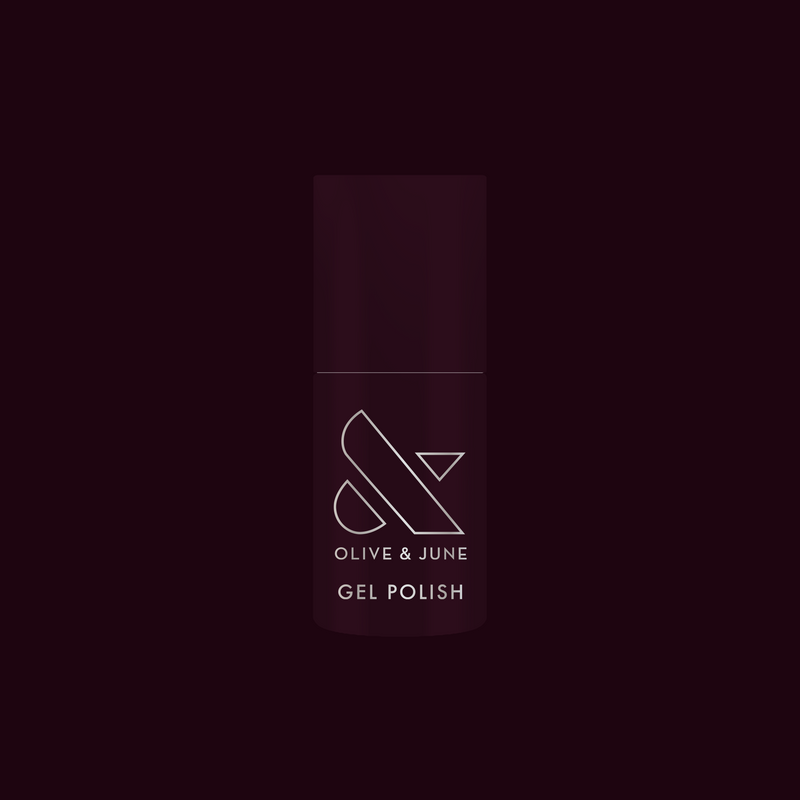 Bottle of Covet - Gel nail polish in a cool deep plum shade with Olive and June branding on dark background
