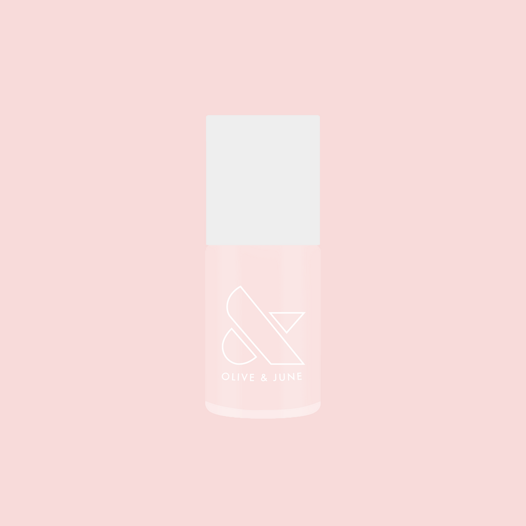 Bottle of FIRST DATE nail polish in soft milky strawberry pink with subtle silver shimmer on a pink background