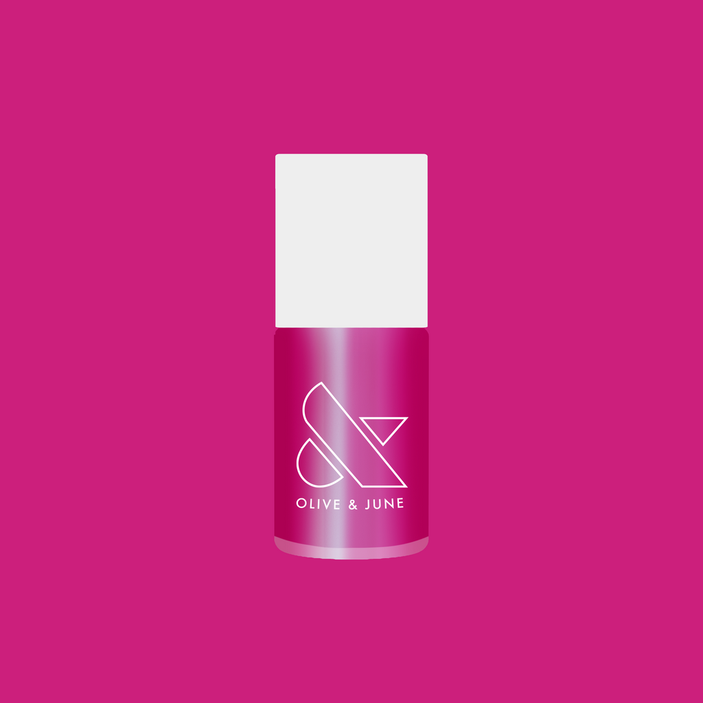 Bottle of HARD LAUNCH quick dry polish in pinky-purple iridescent duochrome shade on a solid pink background