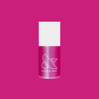 Bottle of HARD LAUNCH quick dry polish in pinky-purple iridescent duochrome shade on a solid pink background