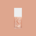 Olive and June Cookie Swap nail polish bottle with shimmery beige champagne gel polish on peach background