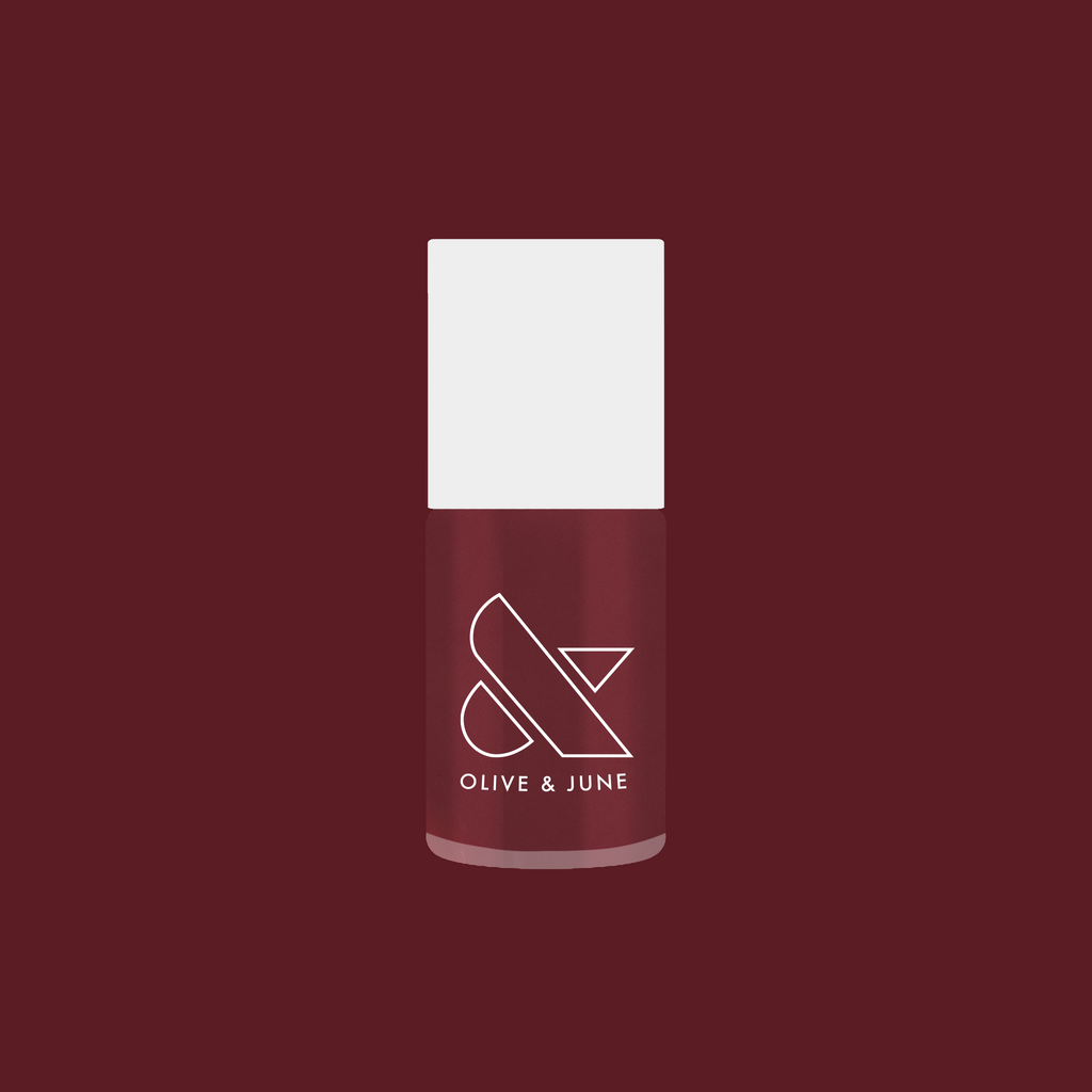 Olive and June polish bottle in Don’t Spill on the White Couch deep dusty berry red gel polish shade