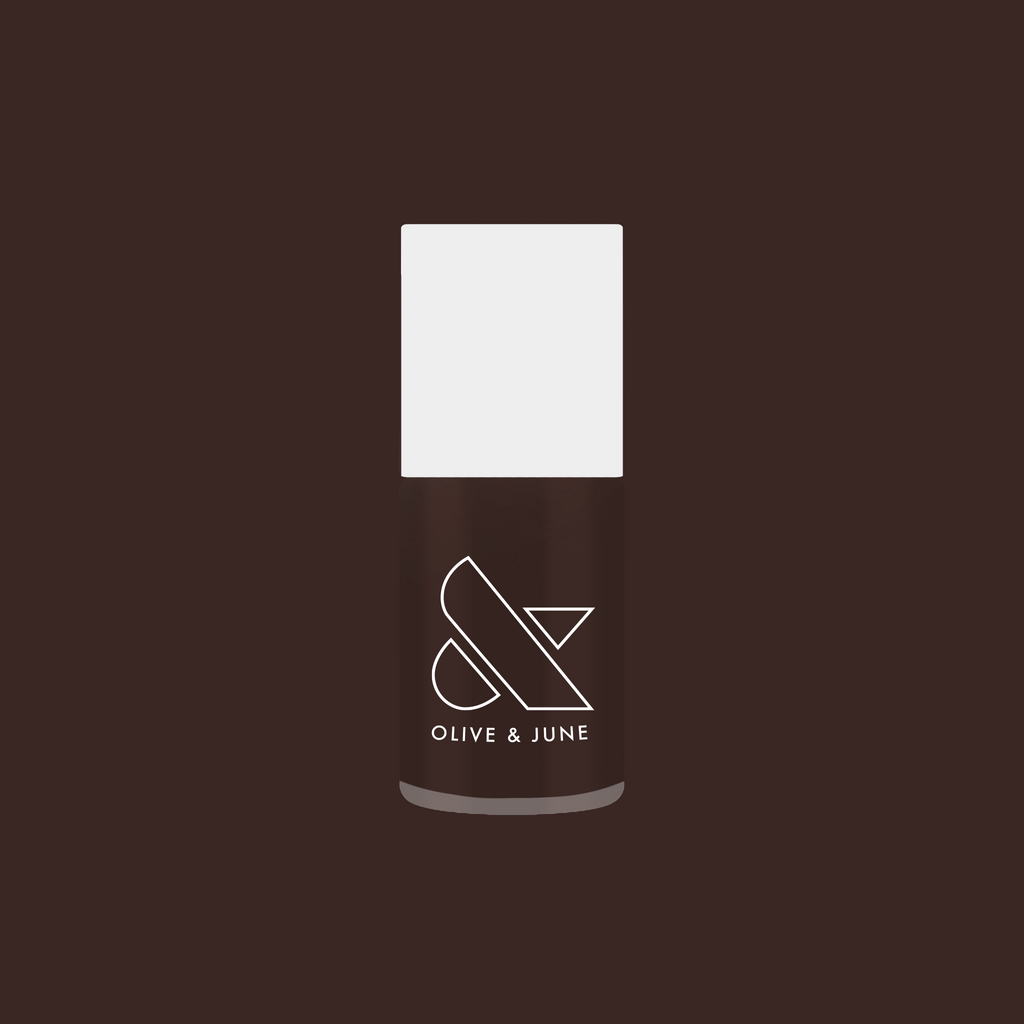 Olive and June Dark Chocolate nail polish bottle on deep brown background for rich manicure looks
