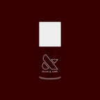 Garnet Glass nail polish bottle with deep scarlet gel color against a rich dark red background