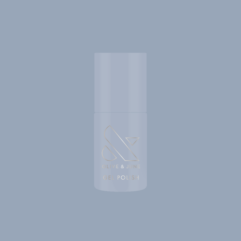 Vintage - Gel polish bottle in vintage denim blue shade on matching blue background by Olive and June