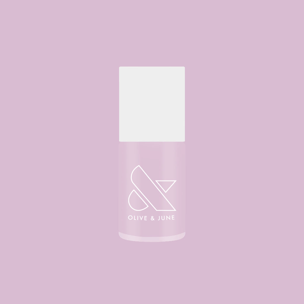 Bottle of Passionfruit Gloss quick dry gel polish in milky lavender shade on soft purple background