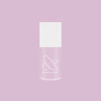 Bottle of Passionfruit Gloss quick dry gel polish in milky lavender shade on soft purple background