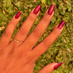 Budget? What Budget deep rose-orange duochrome gel polish on almond-shaped nails for a luminous mani by Olive and June