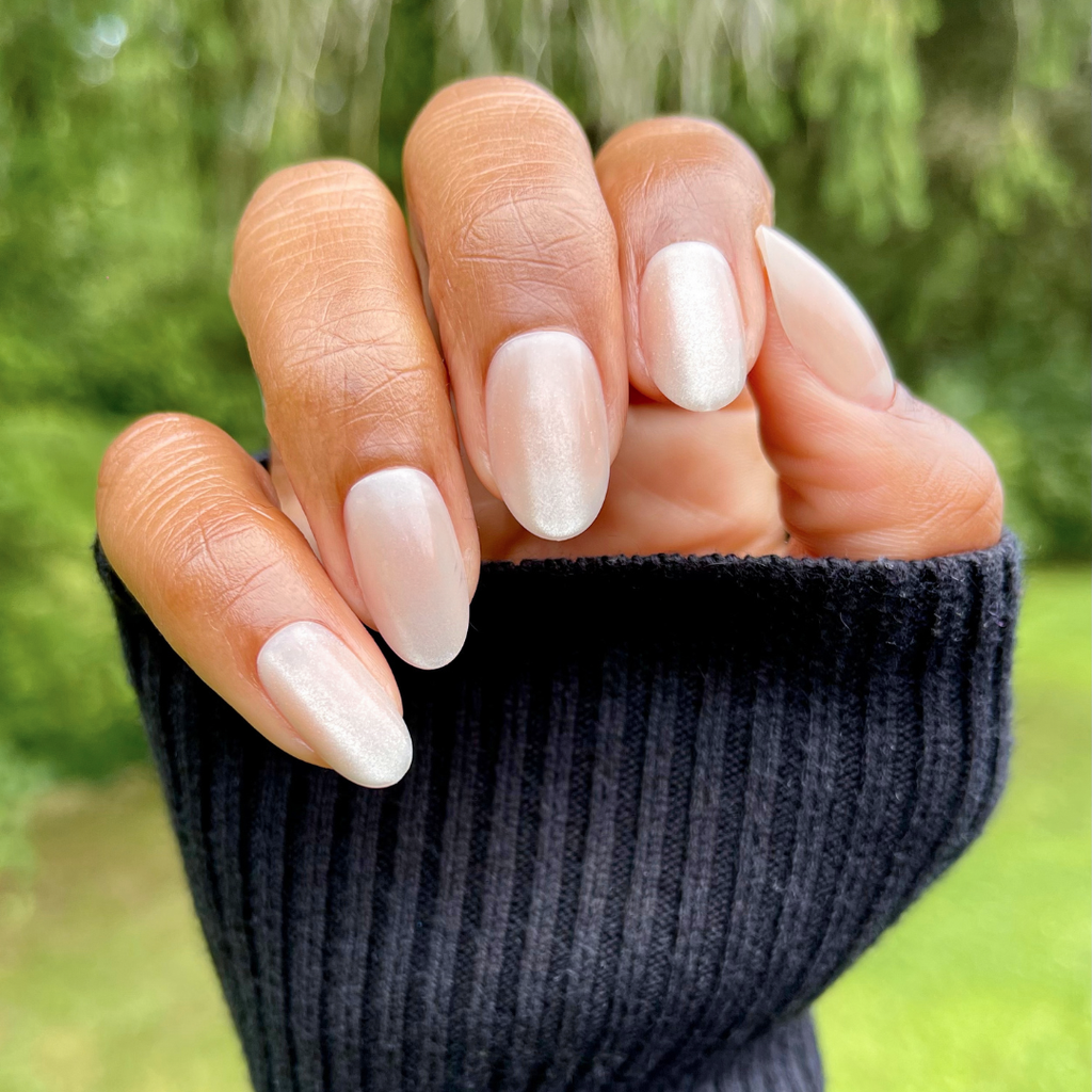 CDJ Velvet - Press-On | Medium | Oval natural hand with shimmery grey-beige nails and soft velvet texture outdoors