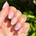 Tie Dye - Press-On | Short | Round showing hand with soft pastel gradient short round nails in natural light outdoors