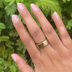 Hand with warm skin tone nails painted in soft iridescent Elevator quick dry polish for a natural at home manicure