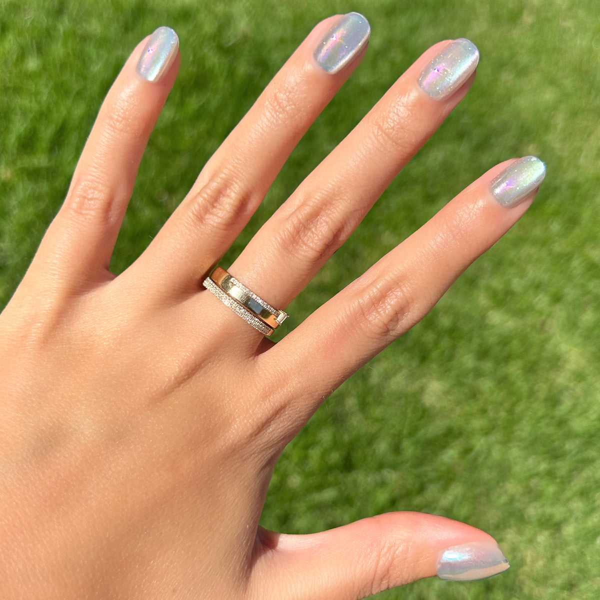 Sheer Lavender Shimmer - Press-On | Extra Short | Round showing hand with iridescent lavender shimmer nails in sunlight outdoors