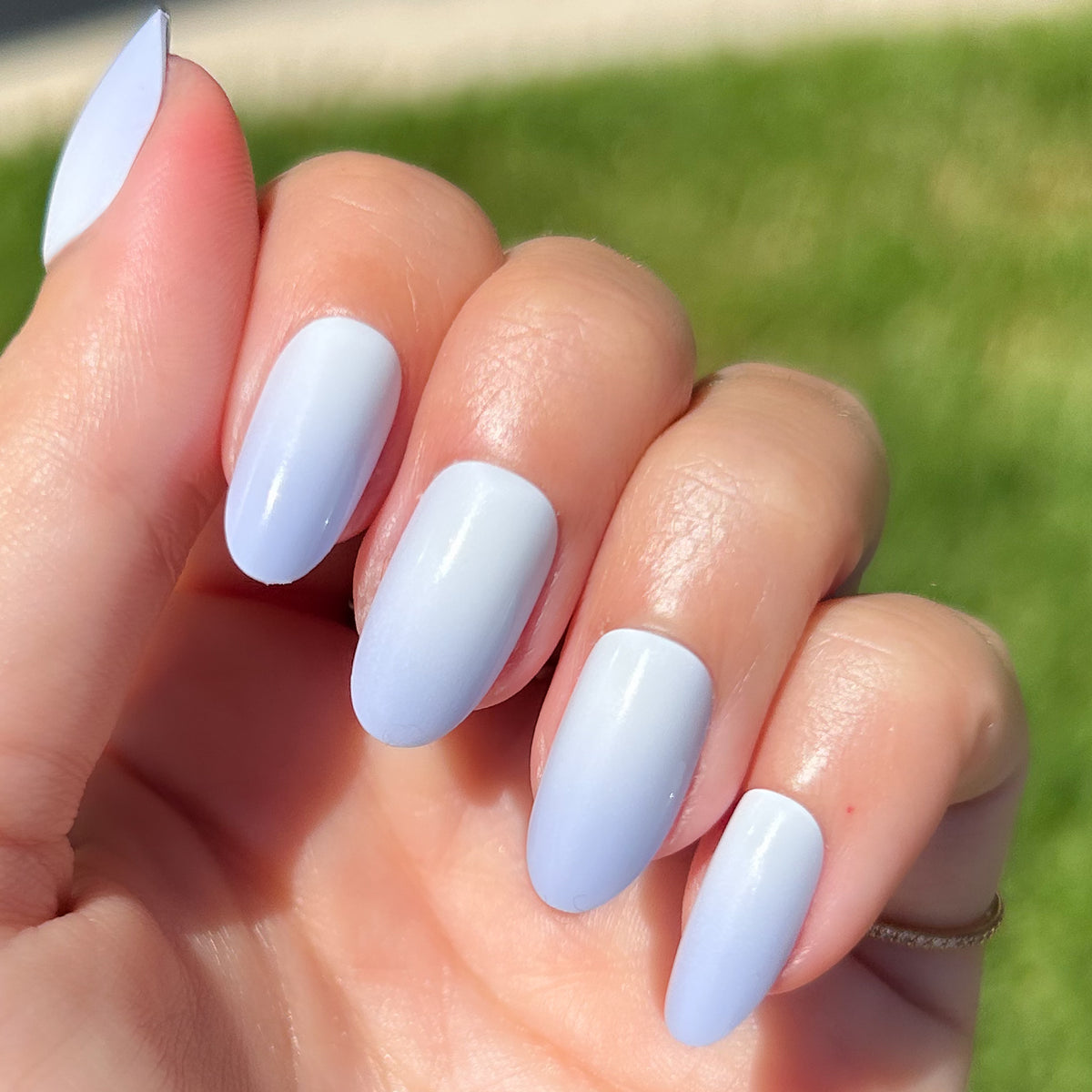 BP Ombre - Press-On | Medium | Almond showing hand with soft blue gradient medium almond press-on manicure outdoors in sunlight