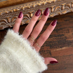 Cabernet | Medium | Oval - Tab Press-On showing glossy medium oval dark plummy red press-on nails for easy at home manicure