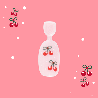 Cherry Whirl - Pressies | Short Medium | Round showing pastel pink press on nails with cherry designs in packaging on pink background Cherry Whirl - Pressies | Short Medium | Round  Pressies